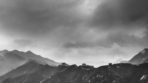 Scenic view of mountains against cloudy sky