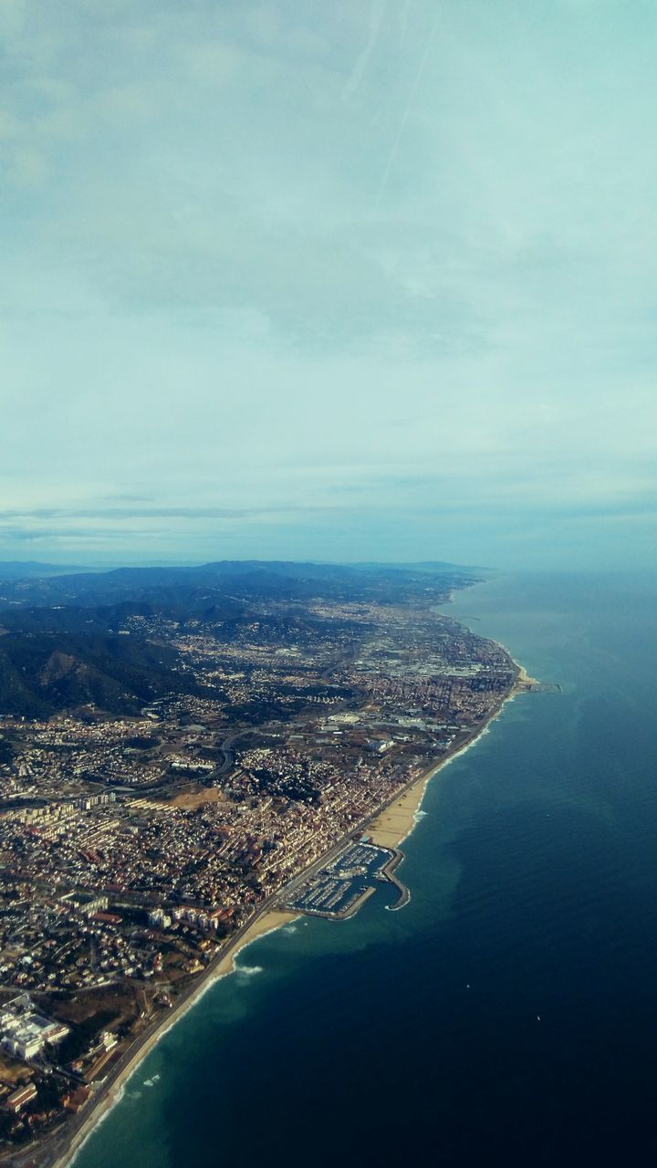 sea, water, aerial view, cityscape, high angle view, city, scenics, architecture, sky, built structure, coastline, building exterior, blue, horizon over water, nature, beauty in nature, tranquil scene, crowded, waterfront, tranquility