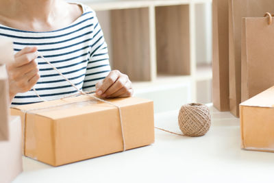 Midsection of woman holding table