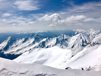 Scenic view of snow covered mountains against sky