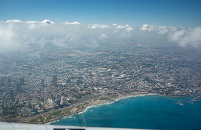 High angle view of sea and buildings against sky