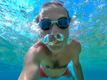 Sea underwater selfie shot of a swimmer with water bubbles