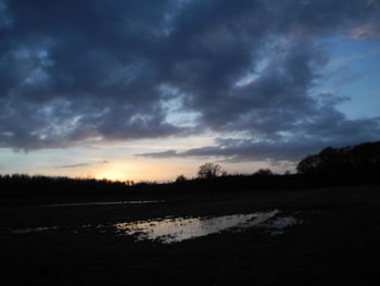 Scenic view of silhouette landscape against sky at sunset