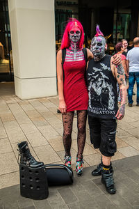 Rear view of women walking on footpath