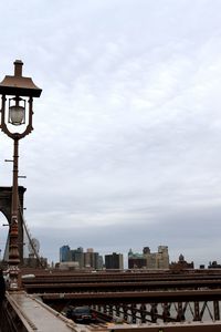 View of cityscape against cloudy sky