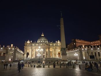 Group of people in illuminated building at night