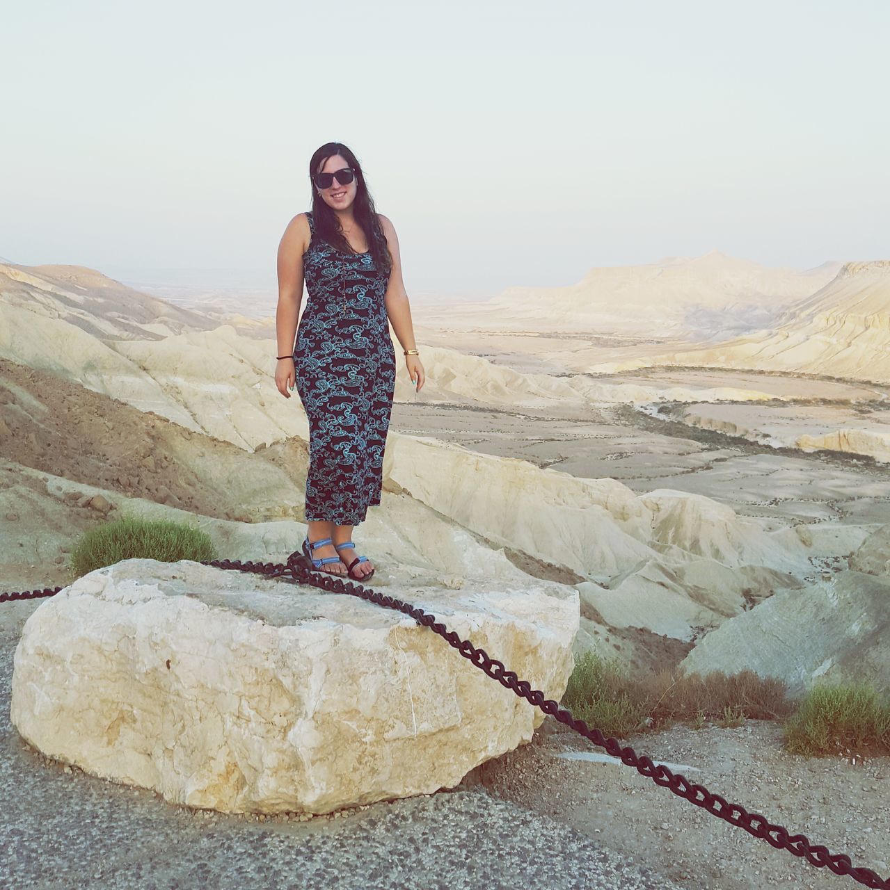 young adult, full length, lifestyles, casual clothing, person, leisure activity, looking at camera, mountain, portrait, young women, standing, front view, rock - object, smiling, mountain range, three quarter length, nature