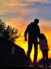 Silhouette of people at sunset