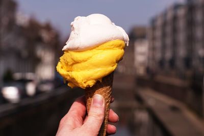 Close-up of hand holding ice cream cone