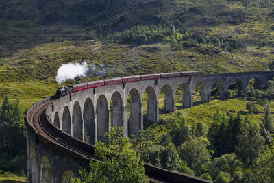 View of steam train on bridge