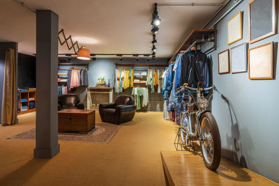 Interior detail of a modern clothing store with hanging clothes