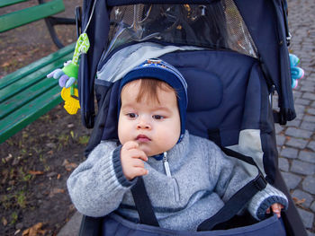 Portrait of a cute baby boy sitting on the swing