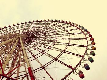 Low angle view of ferris wheel against sky