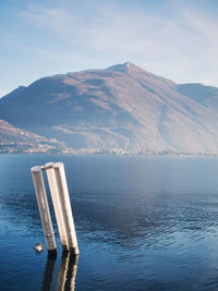 Scenic view of sea and mountains against sky