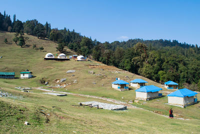 Houses on field against sky