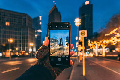 Man photographing at city street