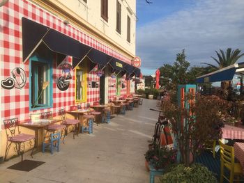 Tables and chairs at sidewalk cafe