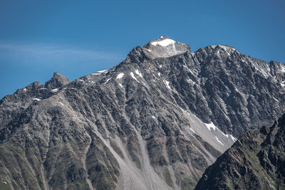 Low angle view of snowcapped mountain against sky