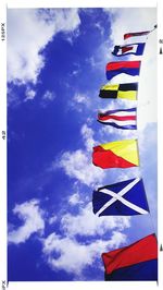 Low angle view of colorful balloons against blue sky