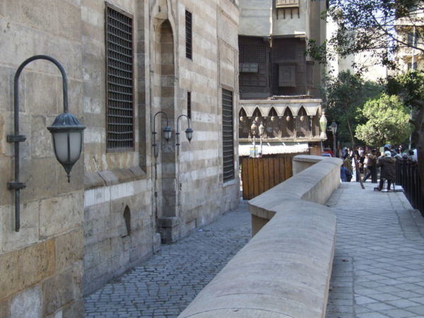 PEOPLE ON STREET AMIDST BUILDINGS