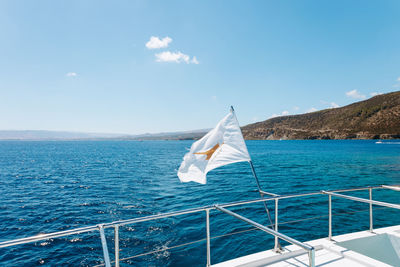 Sailboat sailing on sea against sky