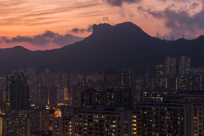 Illuminated cityscape against sky at night