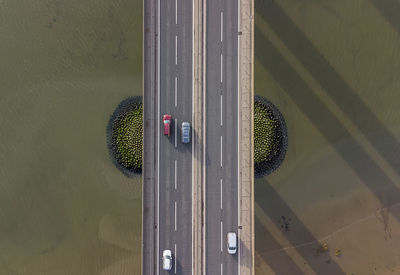 View from a drone looking down on traffic on a road bridge crossing a large river in suffolk, uk