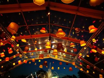 Low angle view of illuminated lanterns hanging at night