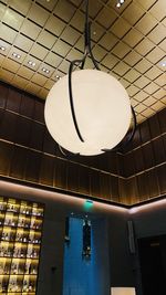 Low angle view of illuminated pendant lights hanging on ceiling