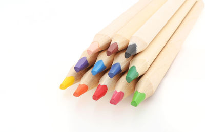 Close-up of multi colored pencils on white background