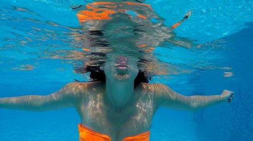 Close-up of shirtless man swimming in pool