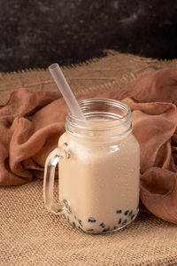 Close-up of drink in glass jar on table