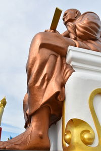 Low angle view of somdej toh statue at wat bot temple against sky
