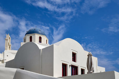 Low angle view of white building against blue sky