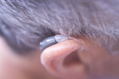 Close-up of man with earring aid