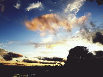 Low angle view of silhouette trees against sky