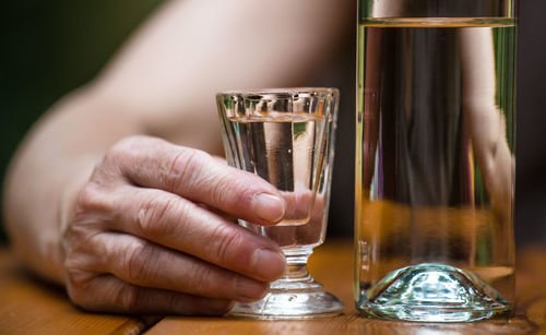 Close-up of hand holding beer glass