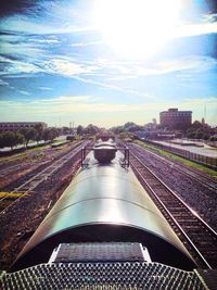 Railroad tracks against cloudy sky