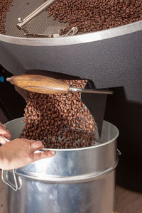 Ready roasted coffee beans are filled in a container