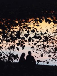 Silhouette people standing by tree during autumn