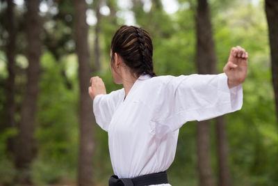 Side view of young woman standing outdoors