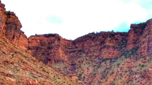 Low angle view of rock formation against sky