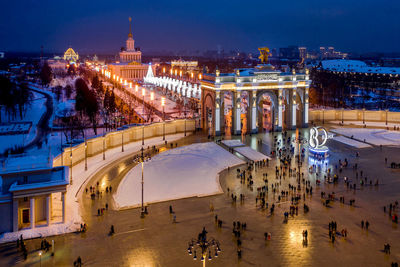 High angle view of city lit up at night