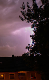 Low angle view of building against cloudy sky