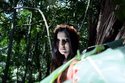 Portrait of young woman in forest