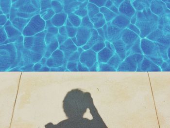 Low section of person on swimming pool