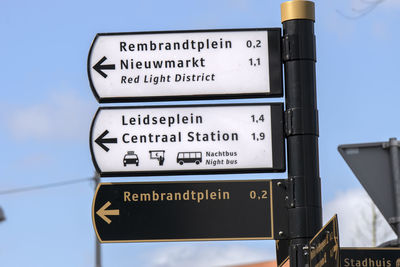 Low angle view of road sign against sky