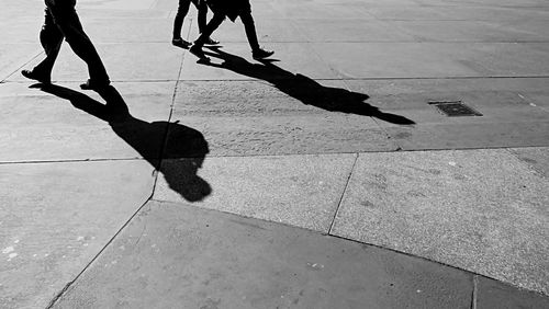 Low section of people standing on footpath