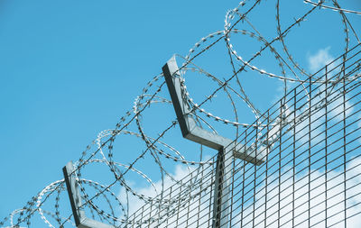 Low angle view of barbed wire against clear sky