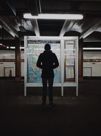Full length of woman standing by railing